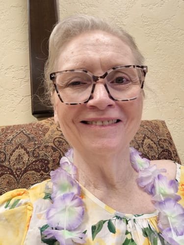 Customer's face wearing glasses after using Koriderm Time Reverse Neck Cream